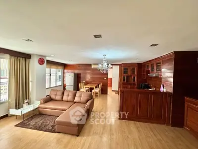 Spacious living room with wooden accents and open layout in modern apartment.