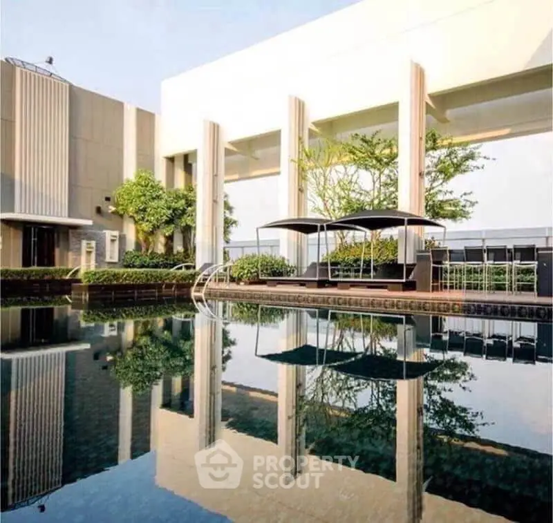 Luxurious rooftop pool with modern design and lush greenery, perfect for relaxation and leisure.