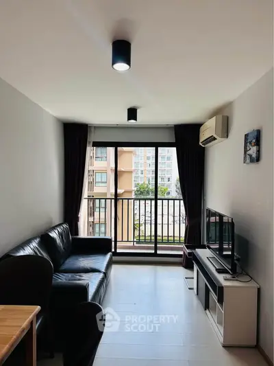 Modern living room with balcony view and sleek furnishings