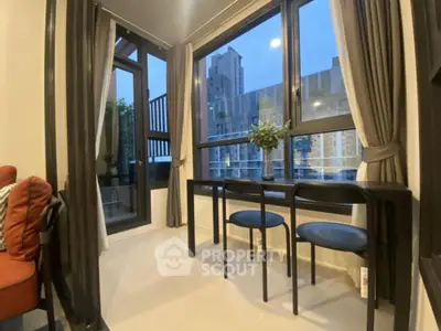 Elegant corner unit with expansive windows offering a serene city view, complemented by modern furnishings and a cozy balcony.
