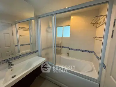 Modern bathroom with sleek bathtub and stylish fixtures in a contemporary home.