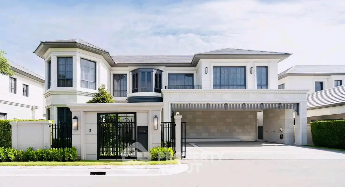 Luxurious modern mansion with grand entrance and spacious driveway, perfect for upscale living.