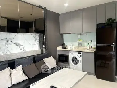 Modern living room with sleek kitchen appliances and stylish decor