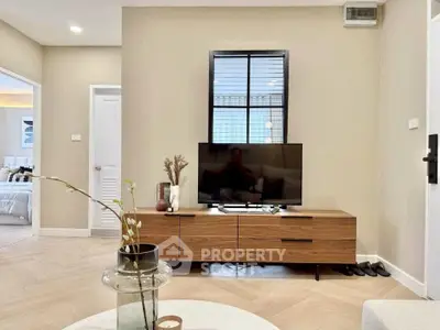 Modern living room with stylish wooden TV stand and cozy decor