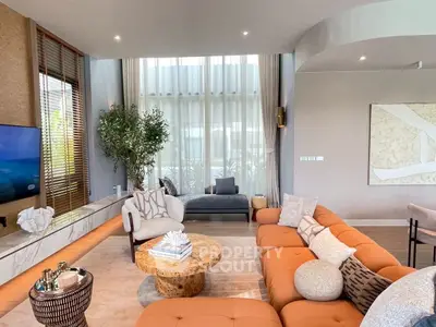 Luxurious living room with modern decor and large windows for natural light.