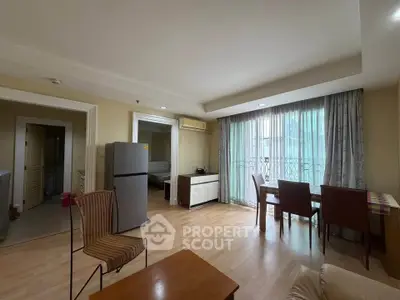 Spacious living room with dining area and natural light