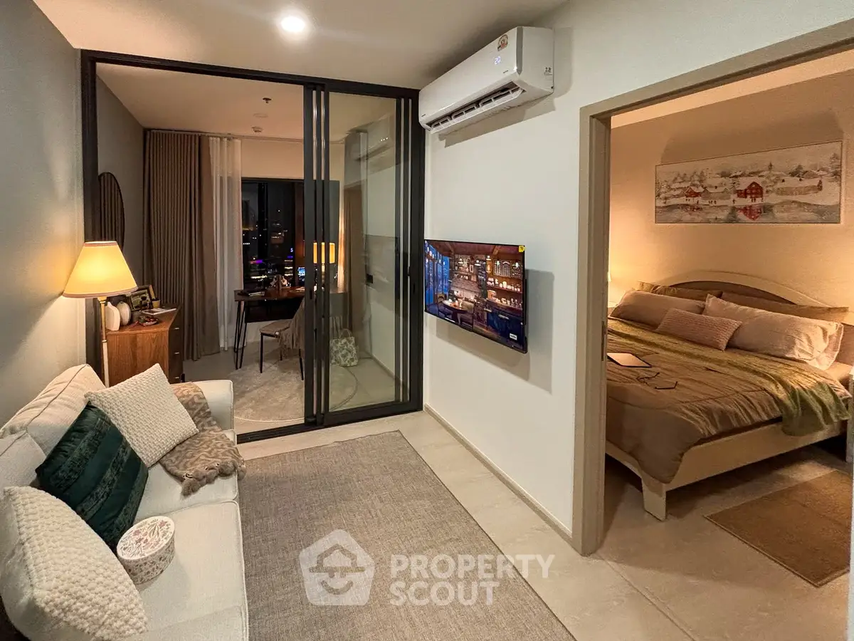 Modern living room with cozy bedroom, stylish decor, and ambient lighting in a contemporary apartment.