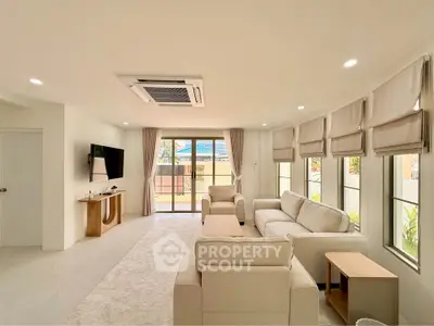 Spacious living room with modern furniture and large windows offering natural light.