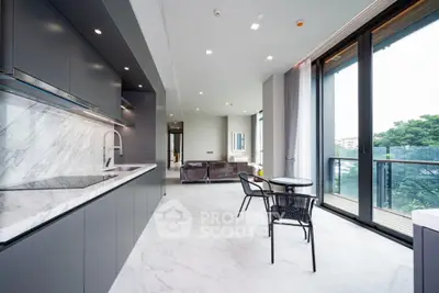 Luxurious open-plan kitchen and living area with modern design and balcony view