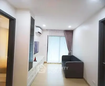 Modern living room with sleek design and natural light, featuring a cozy sofa and stylish decor.