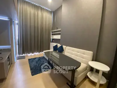 Modern living room with sleek furniture and floor-to-ceiling curtains