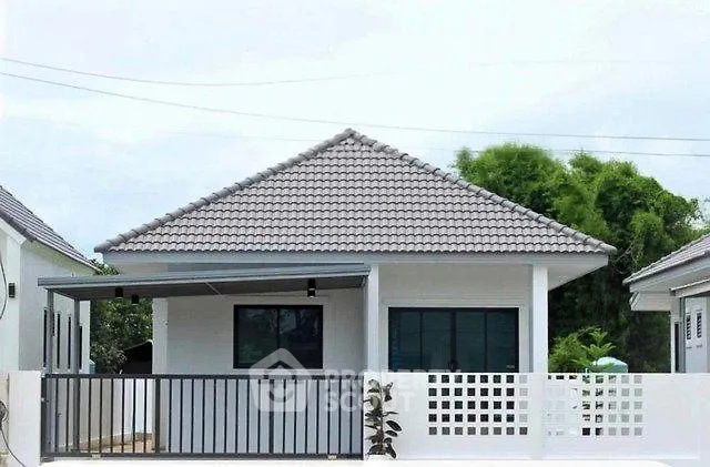 Charming single-story house with modern design and spacious front yard.