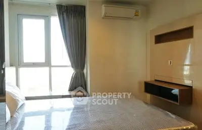 Modern bedroom with large window and air conditioning unit, perfect for comfortable living.