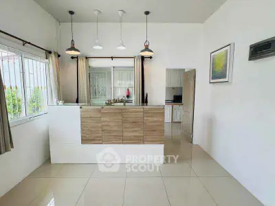 Modern kitchen with sleek design and open layout, featuring stylish lighting and ample natural light.