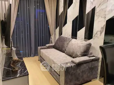 Modern living room with elegant marble accents and plush gray sofa