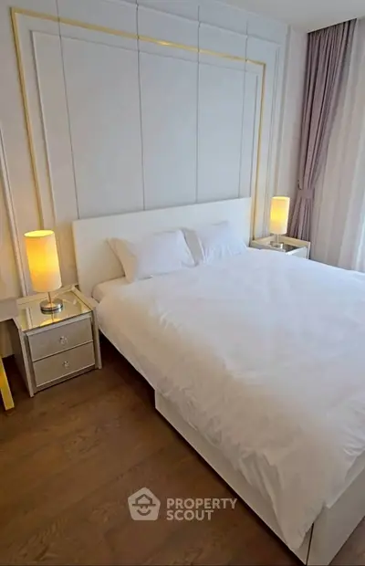 Luxurious bedroom with elegant decor and soft lighting, featuring a plush bed and stylish nightstands.