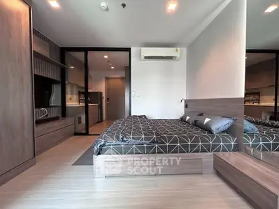 Modern bedroom with stylish decor and sleek furniture in a contemporary apartment.