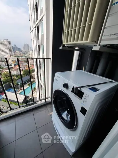 Modern apartment balcony with city view and washing machine