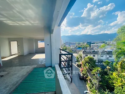 Spacious balcony with stunning city and mountain views, perfect for relaxation and entertaining.