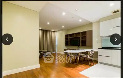 Spacious modern living room with open kitchen and elegant wooden flooring