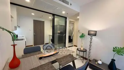 Modern dining area with open kitchen and stylish decor in a contemporary apartment.