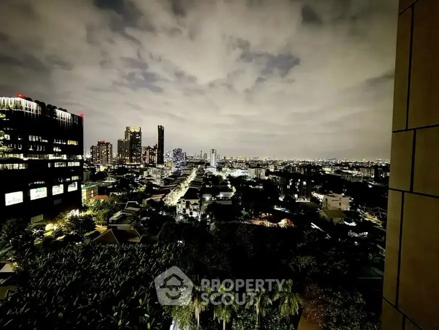 Stunning cityscape night view from a high-rise building balcony.