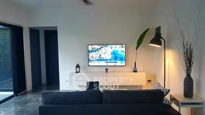 Modern living room with sleek design, featuring a wall-mounted TV and stylish decor.