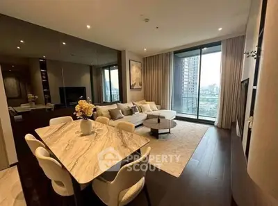 Luxurious modern living room with elegant dining area and stunning city view from large windows.