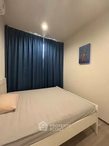 Cozy bedroom with modern decor and soft lighting, featuring a comfortable bed and stylish curtains.