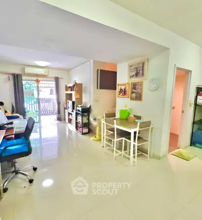 Spacious living room with modern decor and natural light, perfect for family gatherings.