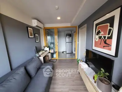 Modern living room with stylish decor and open layout, featuring a cozy sofa and contemporary artwork.