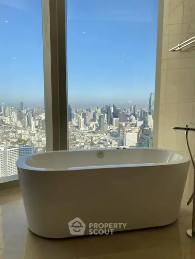 Luxurious bathroom with stunning city view from large window and modern bathtub.