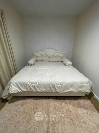 Cozy bedroom with elegant bed and plush rug, perfect for relaxation and comfort.