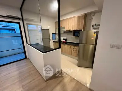 Modern kitchen with stainless steel appliances and open layout in a stylish apartment.