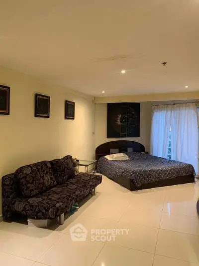 Spacious bedroom with modern decor and natural light