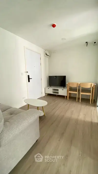 Modern living room with sleek furniture and wooden flooring