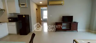 Modern living room with sleek furniture and open kitchen layout