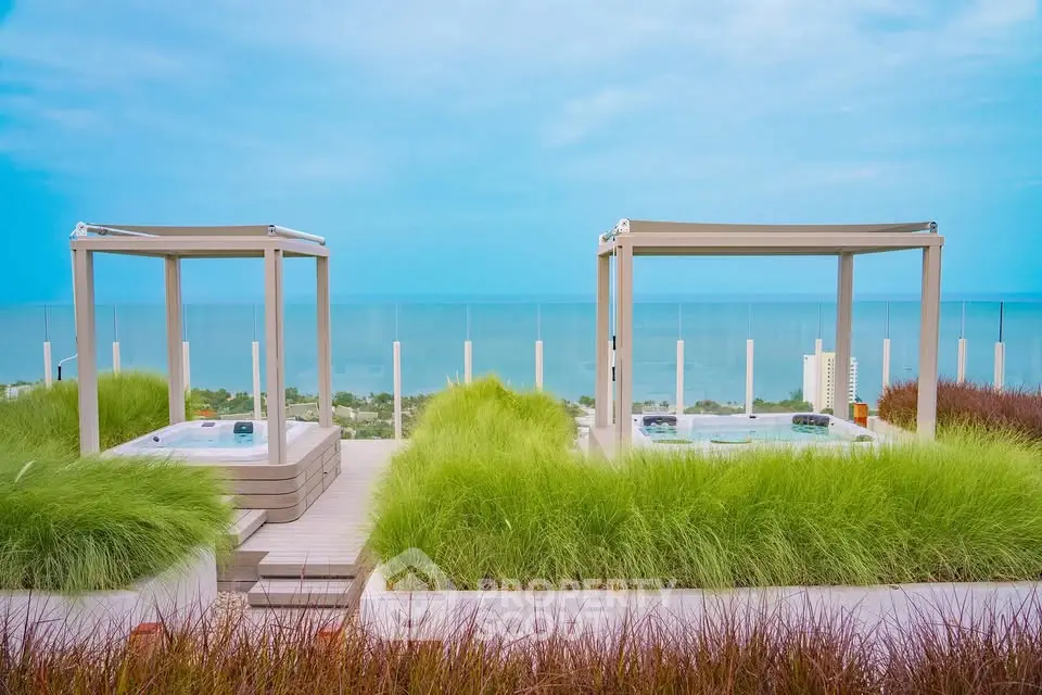 Luxurious rooftop with stunning ocean view and modern jacuzzi setup.