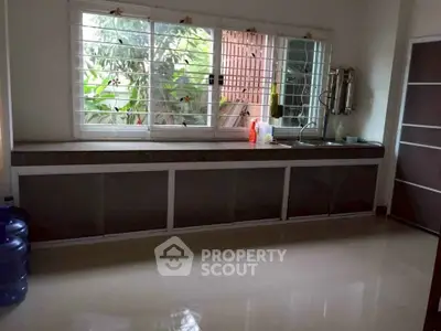 Spacious kitchen with large windows and ample counter space