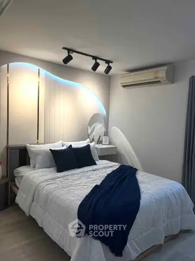 Modern bedroom with stylish lighting and air conditioning