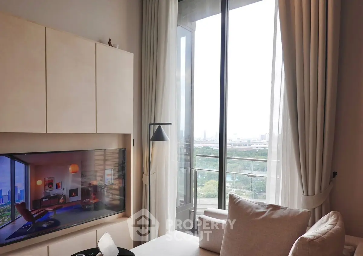 Modern living room with large windows and scenic view, featuring stylish furniture and decor.