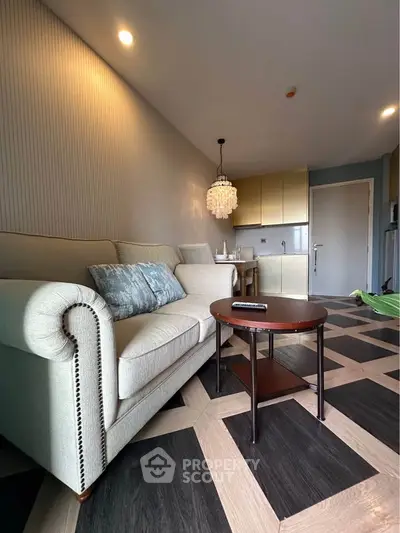Stylish living room with elegant sofa and modern kitchen in open layout apartment.