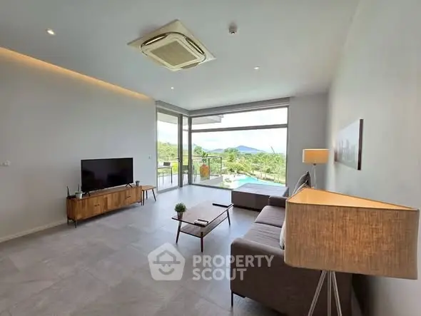 Modern living room with pool view and stylish decor