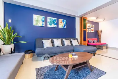 Stylish living room with modern furniture and vibrant blue accent wall