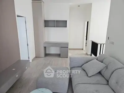 Modern living room with sleek gray furniture and minimalist design