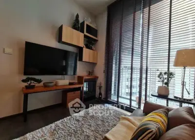 Modern living room with stylish decor and large windows offering natural light.