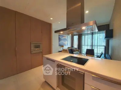Modern open-layout kitchen with sleek appliances and cozy living area, perfect for contemporary urban living.