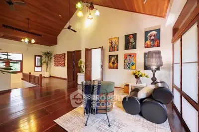 Spacious living room with wooden floors, artistic decor, and cozy seating area.