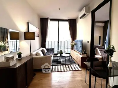 Stylish modern living room with balcony and city view, featuring elegant decor and cozy ambiance.