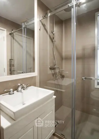 Modern bathroom with glass shower and sleek vanity